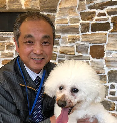 笑顔の男性と白いプードル犬の親しみやすいポートレート